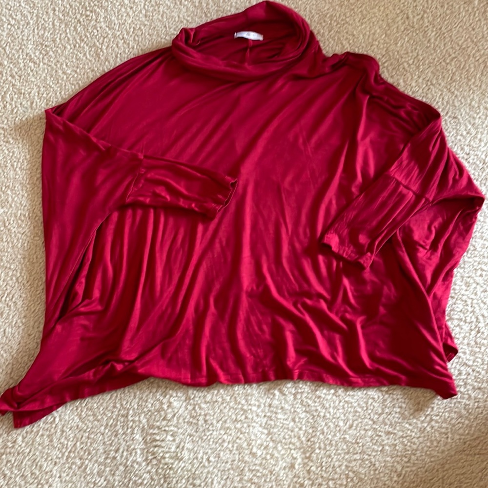 Deep red flowy blouse with dolman style sleeve.